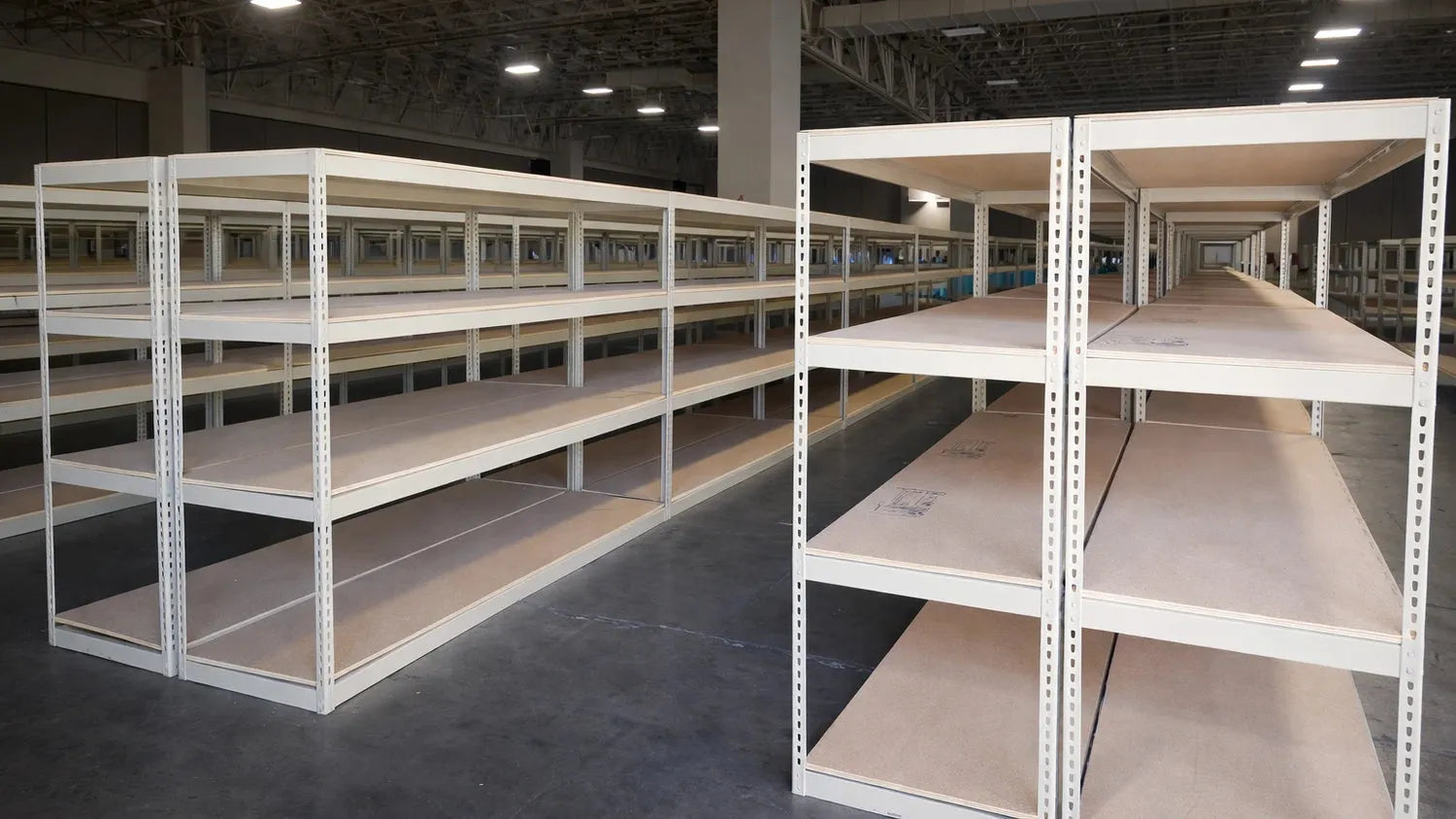 Empty metal shelving units in a warehouse setting